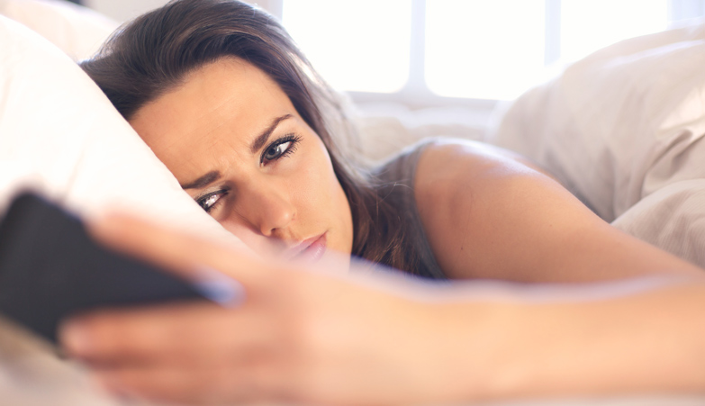 Woman awaking with cellphone